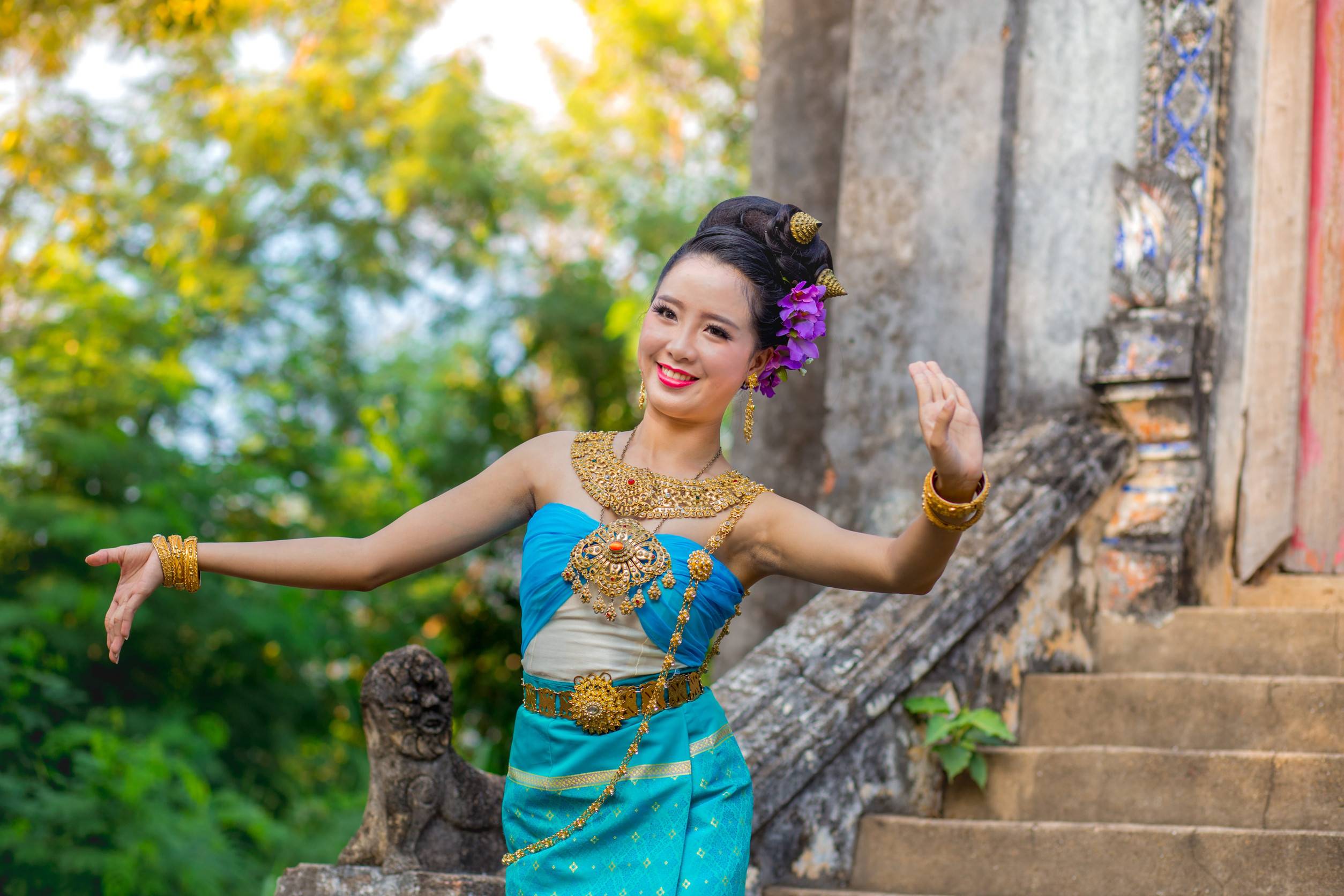 A Thai Woman Dancing In Front Of An Old Thai Temple A Thai Woman Dancing In Front Of An Old Thai Temple