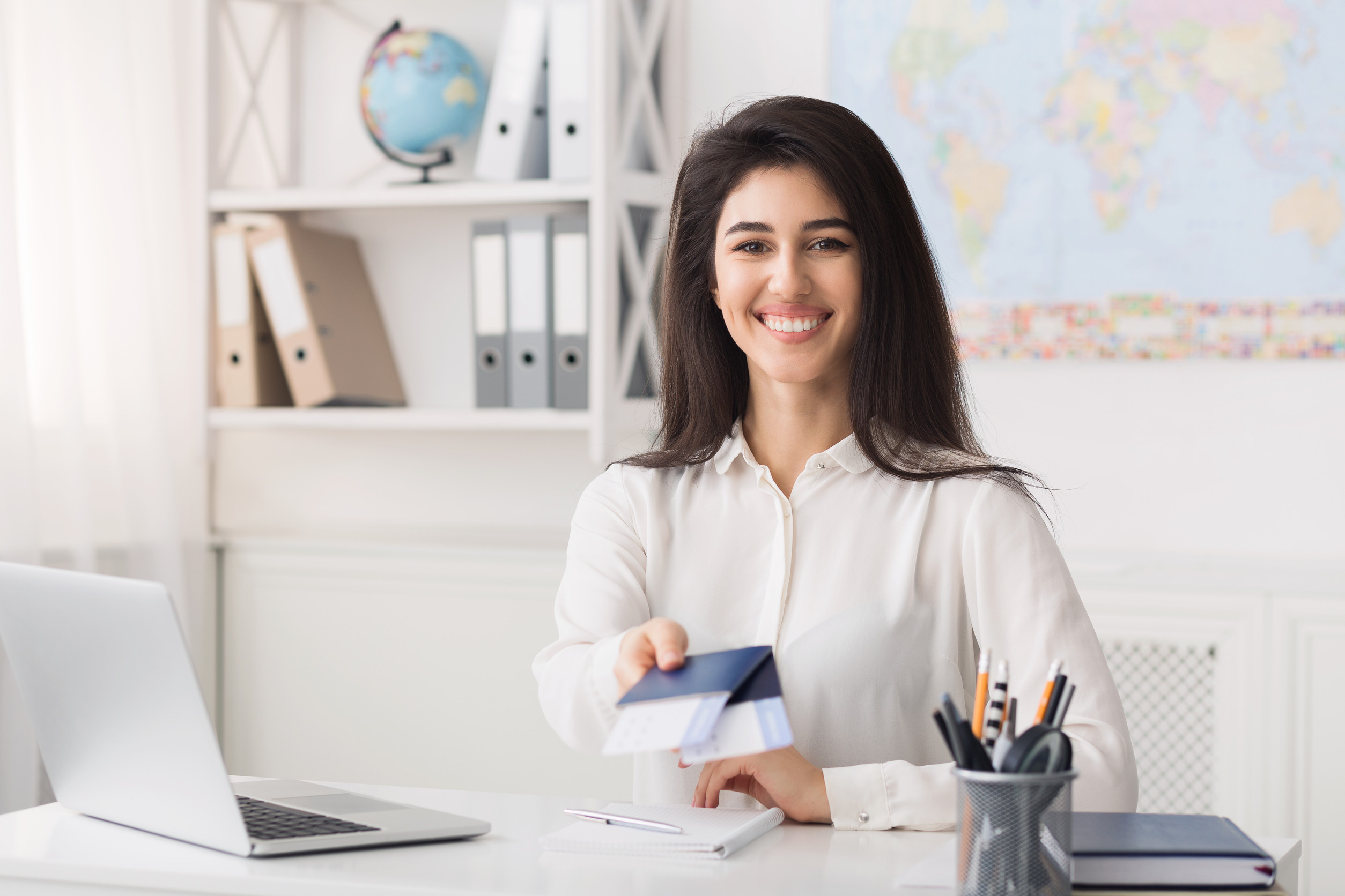 Female Travel Agent Giving Passports With Airline Tickets For Client Free Space Female Travel Agent Giving Passports With Airline Tickets For Client Free Space