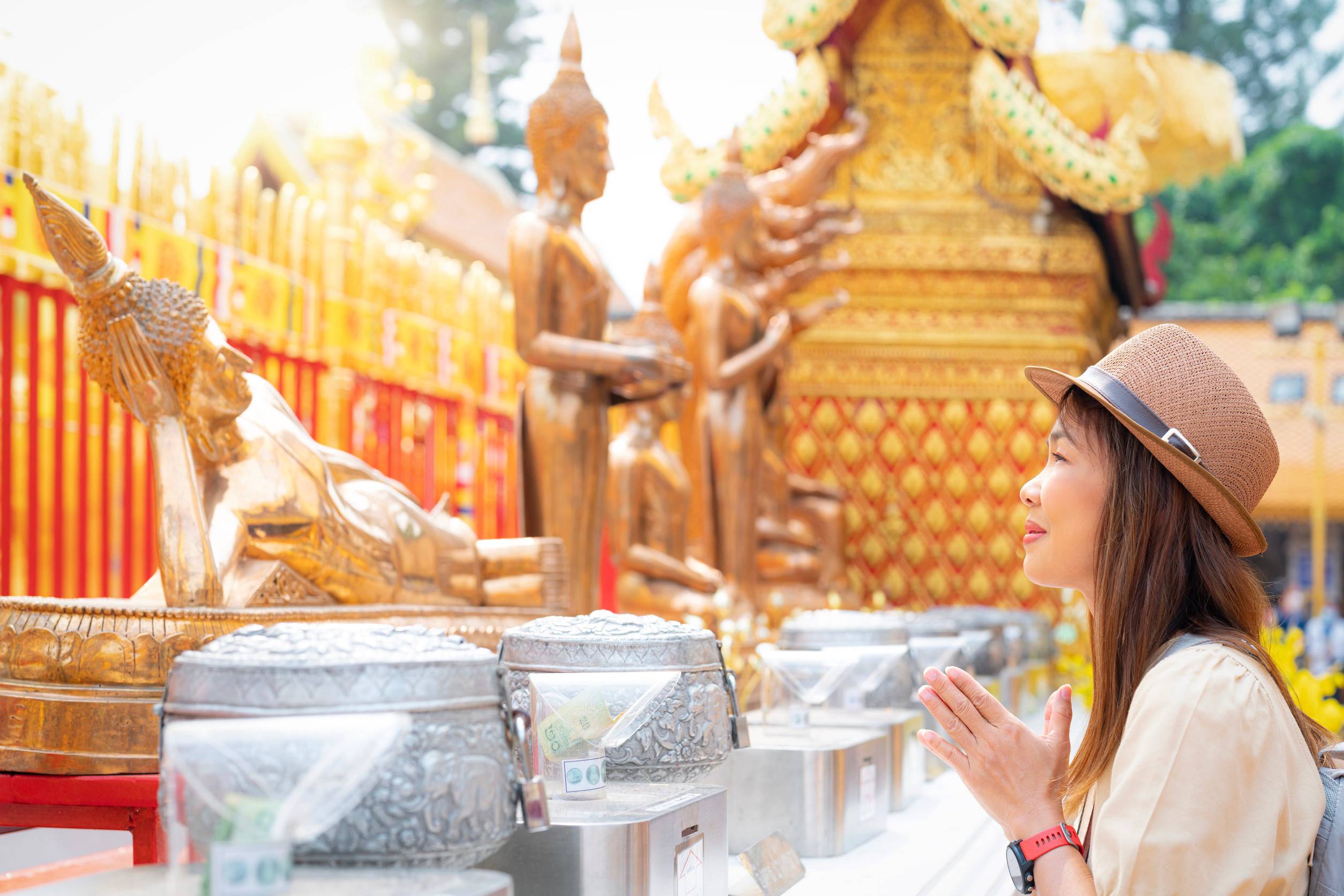 Tourist Praying In Front Of A Bronze Statue In Thailand Tourist Praying In Front Of A Bronze Statue In Thailand